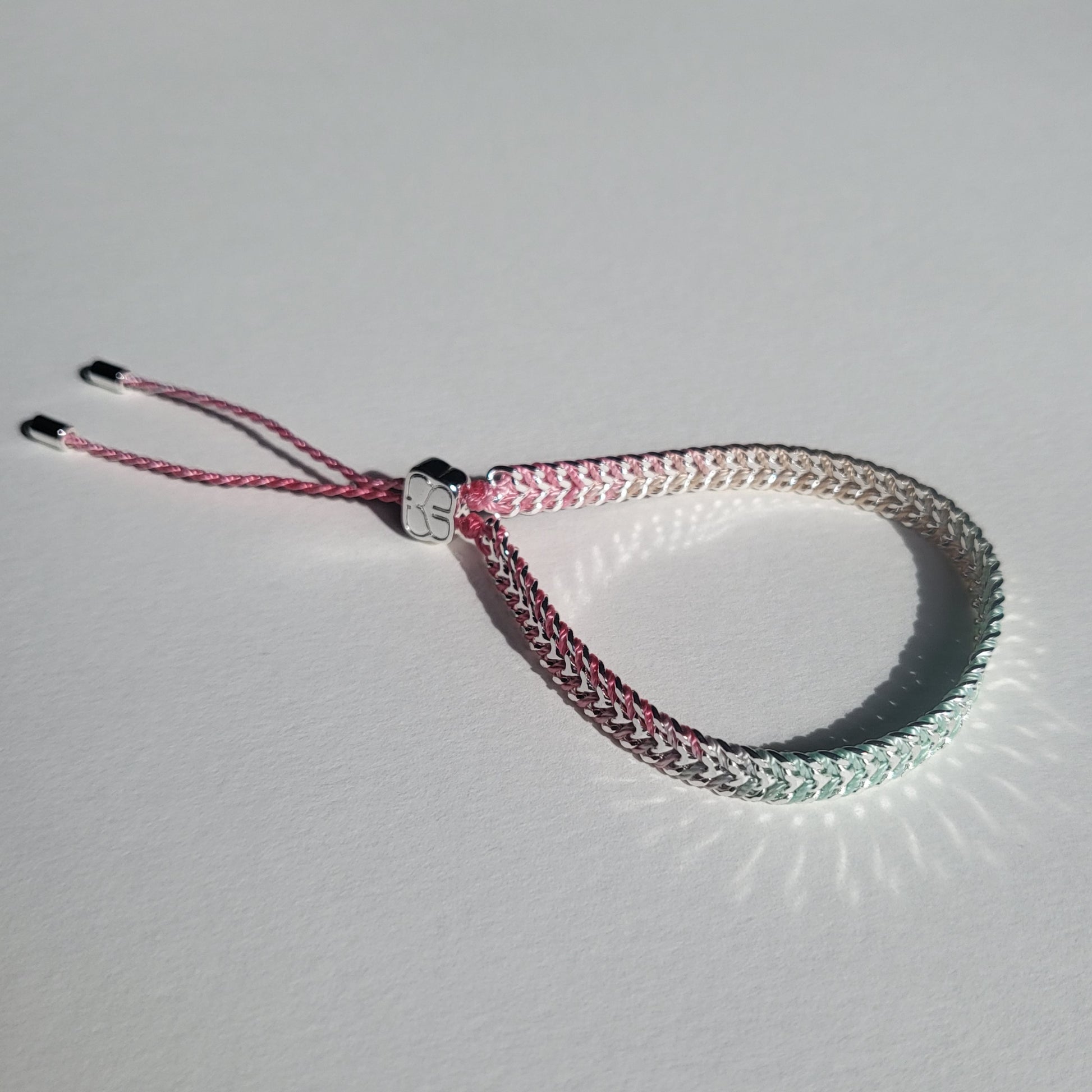 Bracelet with pink and silver design on a light gray background