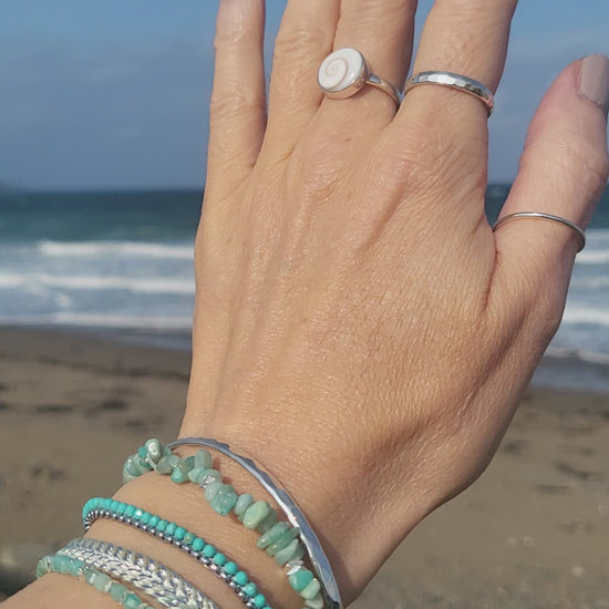 8 piece, bracelet and ring set, hammered silver and gemstone, ocean background